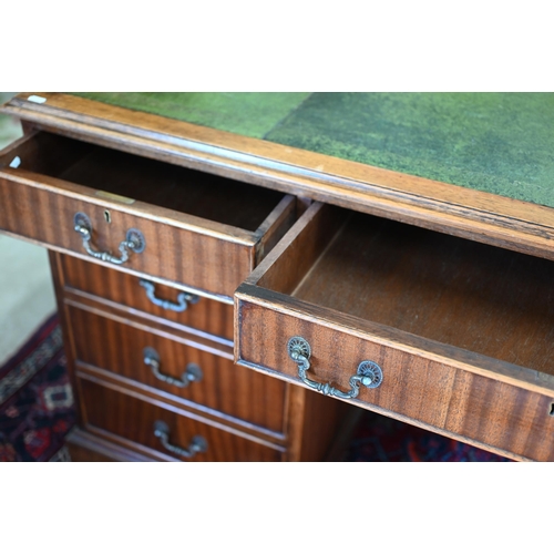 265 - A large reproduction mahogany twin-pedestal desk with gilt-tooled green leather top over eight drawe... 