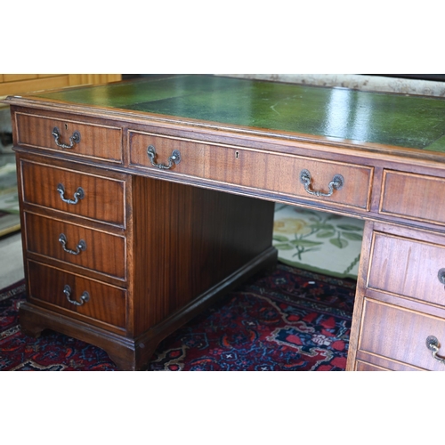 265 - A large reproduction mahogany twin-pedestal desk with gilt-tooled green leather top over eight drawe... 