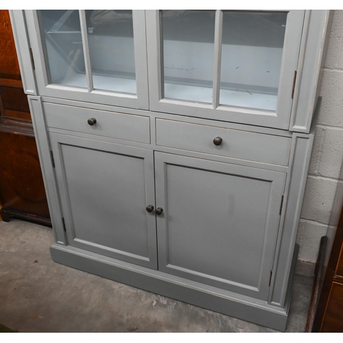 270 - Grey-painted two-section bookcase with glazed and panelled doors divided by two central drawers, on ... 