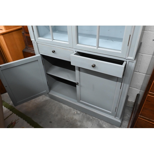 270 - Grey-painted two-section bookcase with glazed and panelled doors divided by two central drawers, on ... 