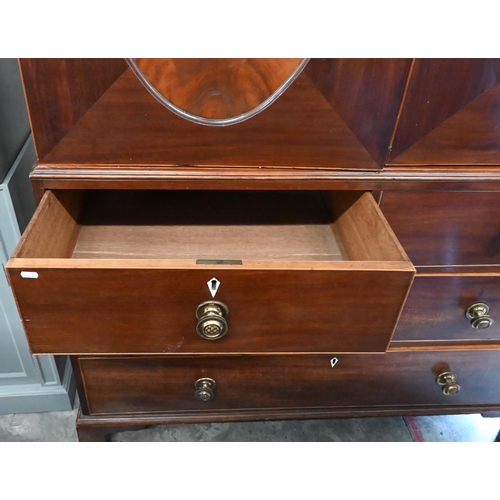 271 - A 19th century mahogany linen press, the top with oval panelled doors enclosing four slides on a che... 