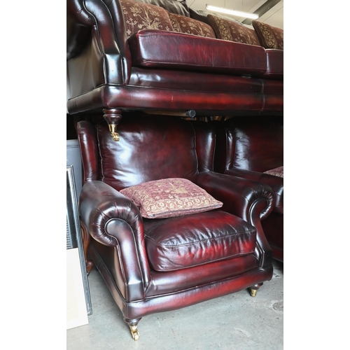 274 - A Thomas Lloyd maroon leather sofa with shaped back and scroll arms, turned mahogany front legs with... 