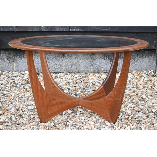 276 - A G-Plan teak 'astro' coffee table, circular inset glass top on shaped base, 84 cm diam x 46 cm high... 