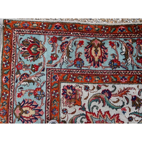 299 - Large Persian Tabriz carpet, traditional floral design on cream ground orange and turquoise palmette... 