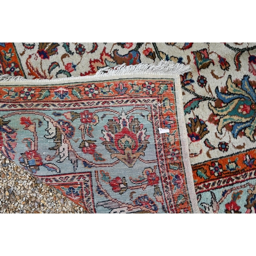 299 - Large Persian Tabriz carpet, traditional floral design on cream ground orange and turquoise palmette... 