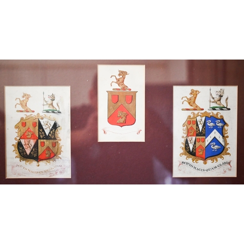 318 - A trio of heraldic crests framed as one, 29 x 48 cm overall