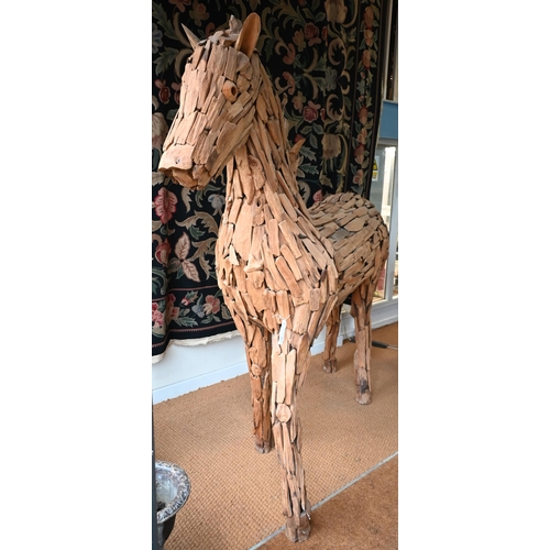 361 - A large driftwood formed sculpture of a horse 220 x 195 cm h