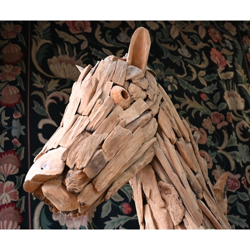 361 - A large driftwood formed sculpture of a horse 220 x 195 cm h