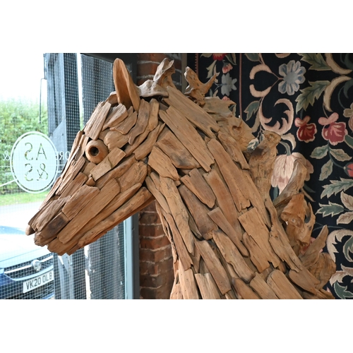 361 - A large driftwood formed sculpture of a horse 220 x 195 cm h