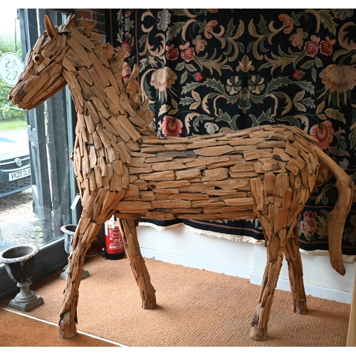 361 - A large driftwood formed sculpture of a horse 220 x 195 cm h