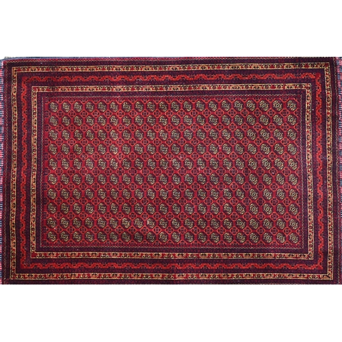 393 - A mid century fine woven Belouch rug, the red-brown ground with repeating geometric designs, 148 x 9... 