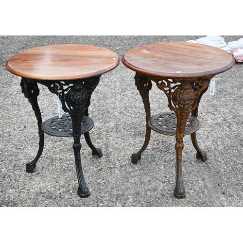 401 - A pair of cast iron Britannia style circular tavern tables with wooden tops (2)