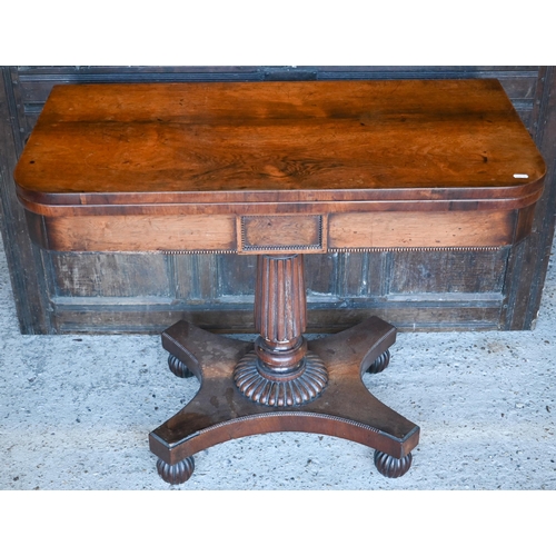 428 - Regency rosewood folding card table, raised on a gadrooned support to a platform base, on castors, 9... 