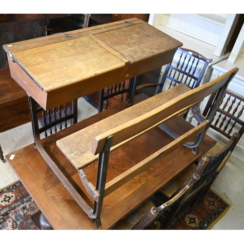 434 - A vintage steel framed oak twin bench seat school desk with twin hinged slope tops, 102 x 74 x 67 cm... 