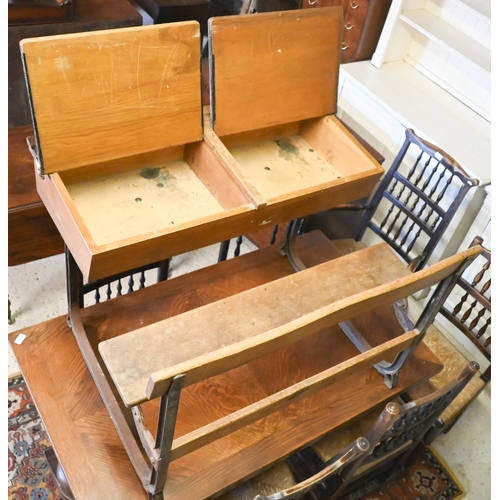 434 - A vintage steel framed oak twin bench seat school desk with twin hinged slope tops, 102 x 74 x 67 cm... 