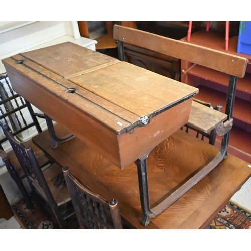 434 - A vintage steel framed oak twin bench seat school desk with twin hinged slope tops, 102 x 74 x 67 cm... 