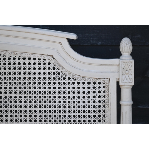 464 - A companion pair of ivory painted cane panelled king size bed heads, 160 x 117 cm h (2)