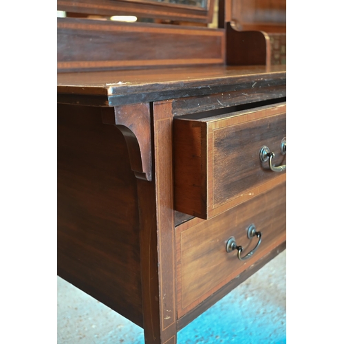 468 - An Edwardian crossbanded satinwood mirror-backed dressing chest with two long drawers on square tape... 