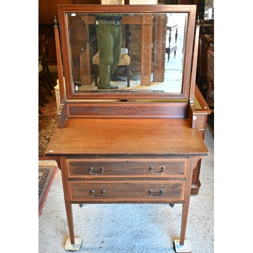 468 - An Edwardian crossbanded satinwood mirror-backed dressing chest with two long drawers on square tape... 