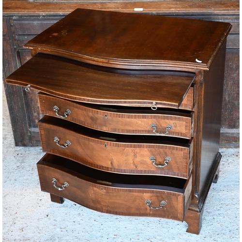 471 - A reproduction Georgian style serpentine chest of four long graduated drawers beneath a brush slide,... 