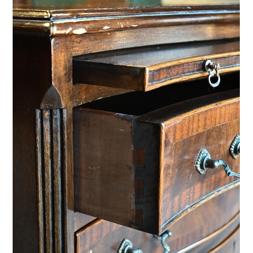 471 - A reproduction Georgian style serpentine chest of four long graduated drawers beneath a brush slide,... 