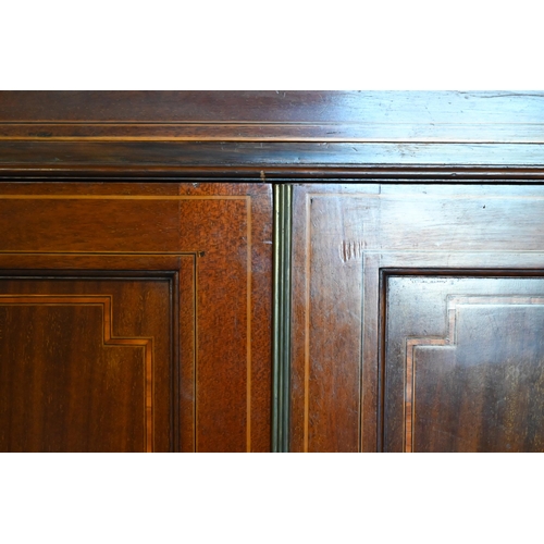 473 - An Edwardian crossbanded satinwood cabinet comprised of a full width drawer over a pair of panelled ... 