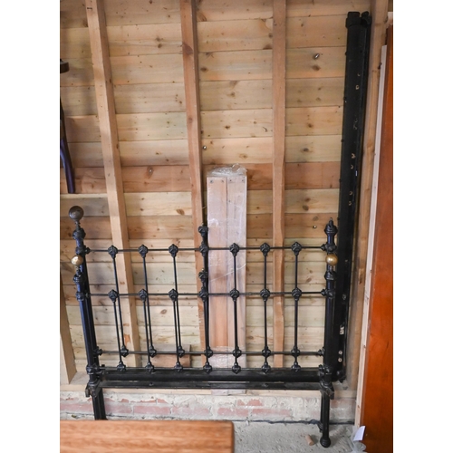 495 - An antique cast iron and brass mounted double bed, painted black with wood slat base (missing 1 bras... 