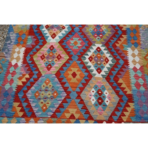 516 - A contemporary Turkish multi-coloured geometric design wool kelim, 199 x 153 cm