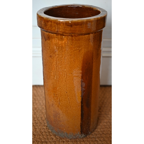 517 - A cylindrical stoneware amber-glazed umbrella/stick stand, 49 cm high