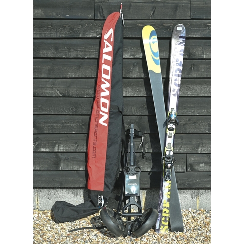 534 - A pair of Salomon Pilot skis in travel bag to/w folding golf trolley (2)