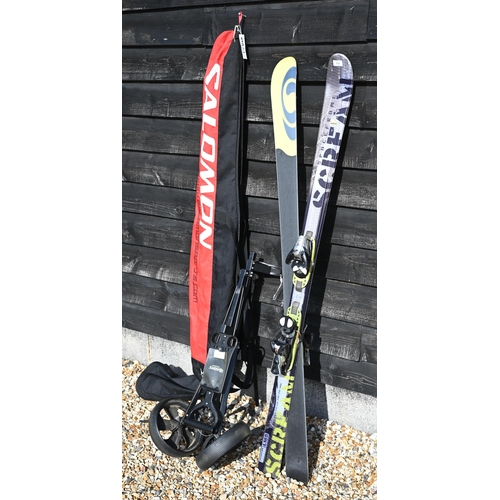 534 - A pair of Salomon Pilot skis in travel bag to/w folding golf trolley (2)