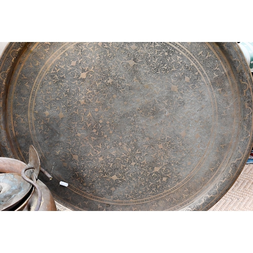 96 - Indian foliate-engraved circular tray, 69 cm to/w a large copper vessel and cover with wrought iron ... 