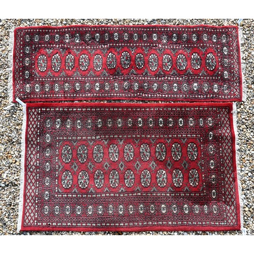 536 - A Tekke Bokhara red ground rug with repeating gul design, 157 cm x 94 cm to/w a Tekke Bokhara runner... 