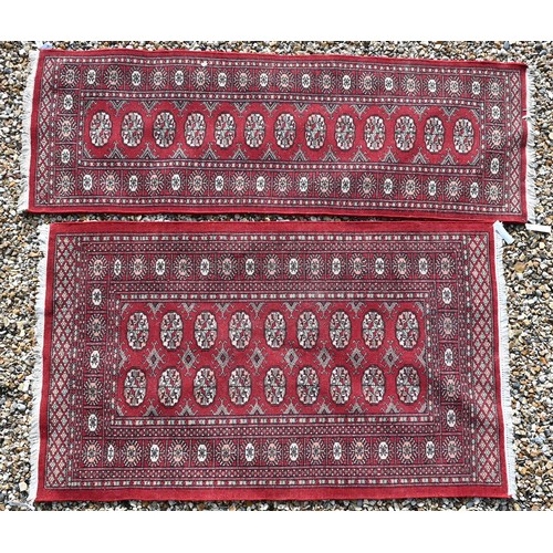 536 - A Tekke Bokhara red ground rug with repeating gul design, 157 cm x 94 cm to/w a Tekke Bokhara runner... 