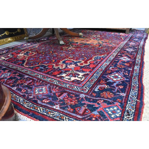 505 - A fine antique Persian hand-made Bidjar rug, the wine-red ground centred by a medallion, 274 cm x 15... 