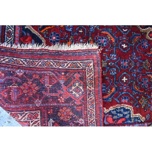 505 - A fine antique Persian hand-made Bidjar rug, the wine-red ground centred by a medallion, 274 cm x 15... 