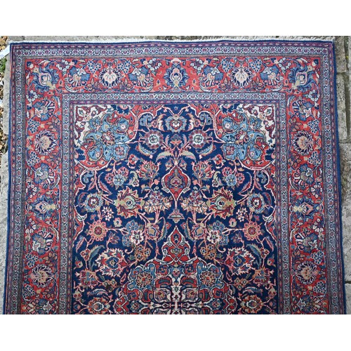 150 - A Persian Kashan rug, palmettes and rosettes arranged symmetrically around the large central floral ... 