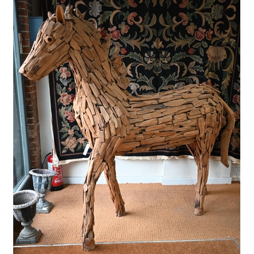 477 - A large driftwood formed sculpture of a horse 220 x 195 cm h