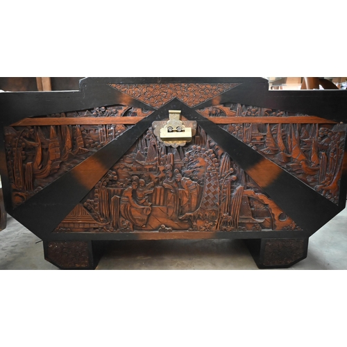 463 - A Chinese hardwood and camphor lined blanket chest extensively carved with figures and landscapes, b... 