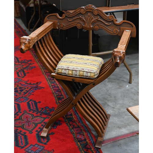 480 - A Continental carved hardwood folding savonarola chair with lion arm terminals