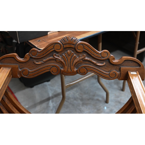 480 - A Continental carved hardwood folding savonarola chair with lion arm terminals