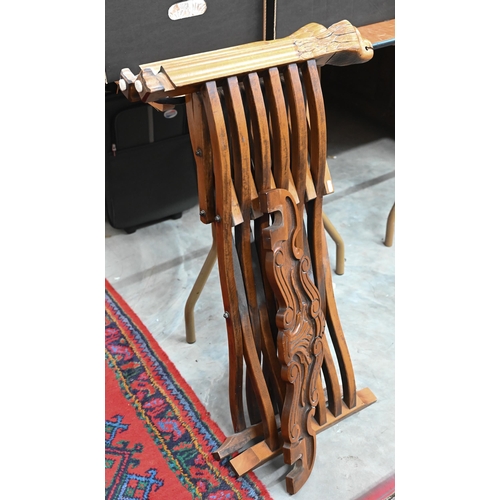 480 - A Continental carved hardwood folding savonarola chair with lion arm terminals