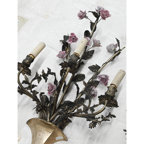 482 - A matched pair of floral and foliate cast three branch metal sconces with ceramic flowers, 75 cm