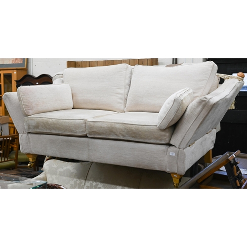 490 - A modern two seater Knole-style sofa with beech finials and legs with front brass casters, cream che... 