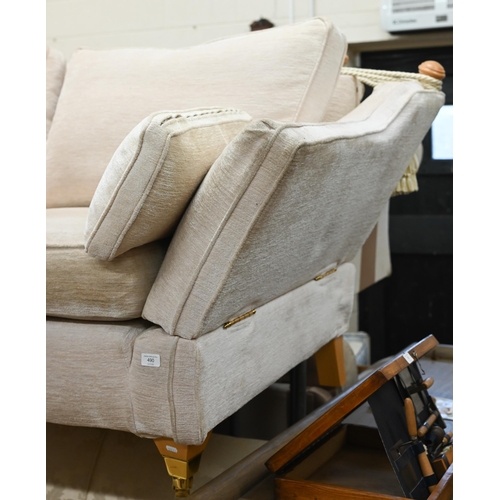 490 - A modern two seater Knole-style sofa with beech finials and legs with front brass casters, cream che... 