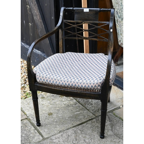 484 - An Edwardian ebonised open armchair with caned seat, a/f