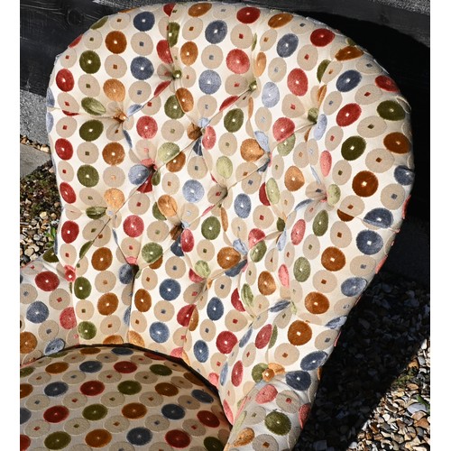 471 - A modern spoonback nursing/bedroom chair with button back multi-coloured circle patterned fabric