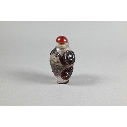 409 - A Chinese Peking cameo glass ovoid snuff bottle with red stopper, the clear glass bottle inside pain... 