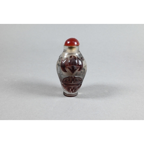 409 - A Chinese Peking cameo glass ovoid snuff bottle with red stopper, the clear glass bottle inside pain... 