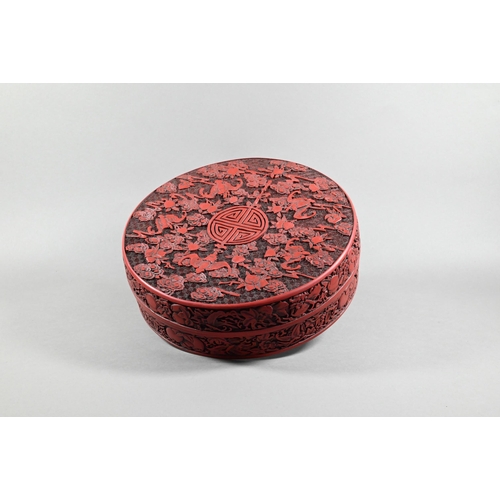 412 - A large Chinese cinnabar lacquer circular box and cover, profusely carved with arrangements of bats,... 